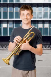 A beginner player holding a trumpet