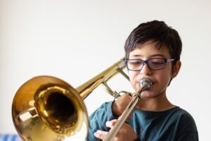 Child testing a trombone