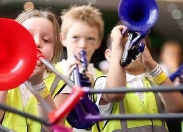 Children playing plastic instruments