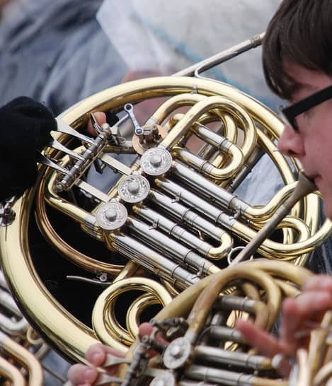 kid playing the french horn