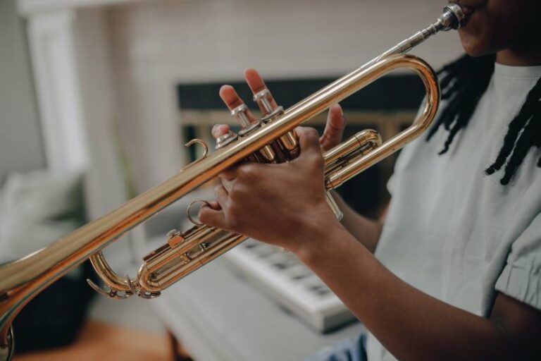 A beginner trumpet player performing at home
